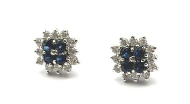 A pair of sapphire and diamond cluster earrings, stamped 750. Weight 3g.