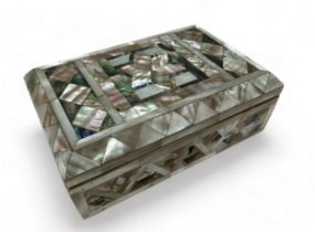 An inlaid mother of pearl hinged jewellery / trinket box on four feet, possibly Victorian.