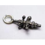 A silver rattle and whistle with mother of pearl teething ring. Chester hallmarks for maker CC.