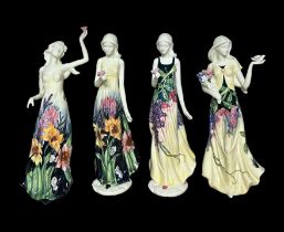 Old Tupton Ware, group of four Old Tupton Ware hand painted young women figurines in floral dresses.