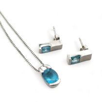 A white gold and topaz necklace with a pair of white gold and topaz earrings. Pendant, earrings