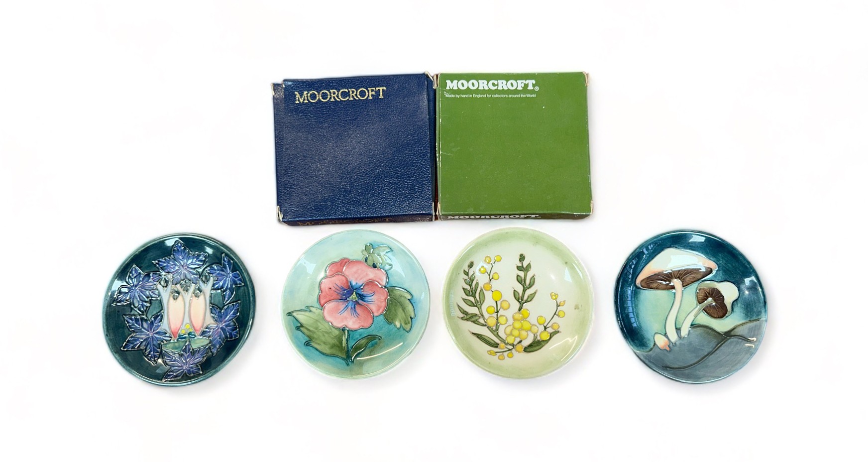 Moorcroft, four Moorcroft pin dish coasters to include; Fairy Ring pattern, Wattle pattern, Cluny