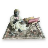 Franz Bergman (Austrian, 1861-1936), late 19th century, cast as an Arab scribe seated on a carpet,