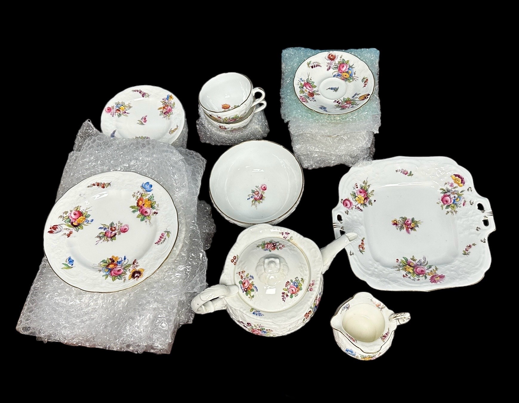 Coalport floral pattern teaset, circa 1900, comprising a teapot, sugar bowl, milk jug, finger