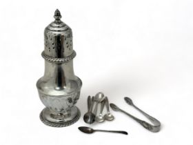 A silver sugar sifter, some sugar tongs and some teaspoons. Sugar sifter with marks for CF (