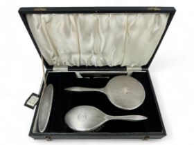 A silver mounted dressing table set by Broadway & Co., Birmingham 1994, comprising hand brush,