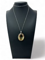 A large smoky quartz pendant on a mount stamped silver and suspended from a chain stamped silver.