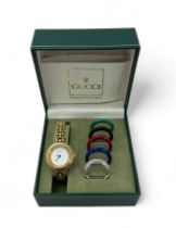 Gucci gold plated lady's bangle wristwatch with five interchangeable coloured ring bezels, with