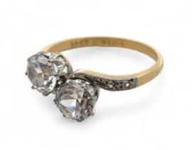 A zircon crossover ring stamped 18ct. Size R. Please see the buyer's terms and conditions for