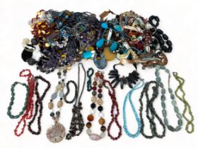 A box of hardstone and costume jewellery. Please see the buyer's terms and conditions for purchasing
