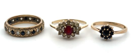 Thee 9ct gold and ruby/ sapphhire rings. A 9ct sapphire flower ring size N, a sapphire and CZ