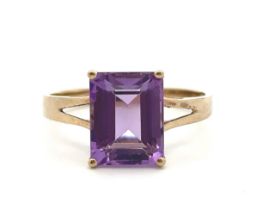 A gold and amethyst ring stamped 9k. Size P. Rectangular step cut amethyst 10mm x 8mm. Please see