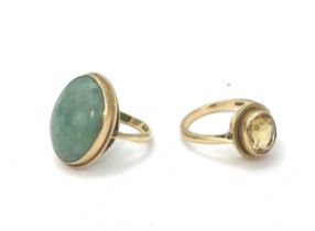 Two hallmarked 9ct gold rings. A ring set with an oval jade cabochon size N, and a yellow quartz