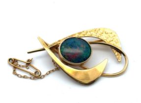 An imitation opal brooch, stamped 9ct. Length40mm, weight 6.13g. Please see the buyer's terms and