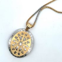 A very attractive yellow and white gold pendant suspended from a two tone 18" foxtail chain. Both