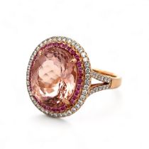 A magnificent morganite, sapphire and diamond cluster ring. The principal morganite measuring approx