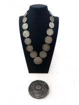 A silver coin necklace made from 19th Century 800 and 900 silver coins such as US trade dollar,
