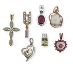Seven 9ct gold and gem set pendants. Includes pink tourmaline, diamond, ruby and diamond, amethyst
