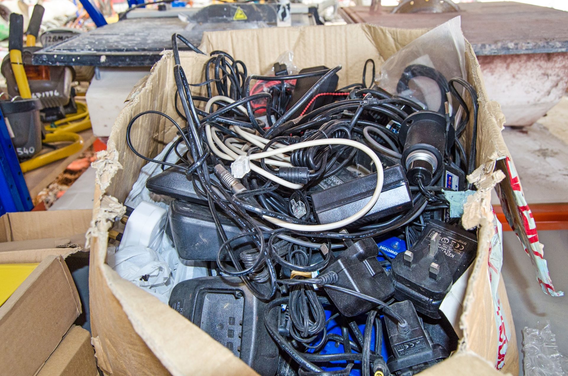 Box of various chargers and leads
