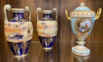 2 Noritake Desert Scene Twin Handled Urns & A German Pottery Lidded Twin Handled Urn Possibly A Dres