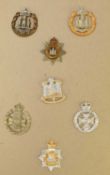 Collection of British military cap badges and buttons