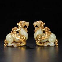 A pair of Hetian jade wrapped with gold and horses