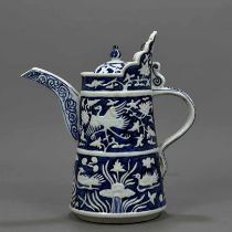 Yuan blue and white embossed monk's hat pot with mandarin ducks playing with lotus pattern