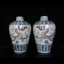 A pair of Hongwu blue and white underglaze red dragon-patterned plum vases of the Ming Dynasty