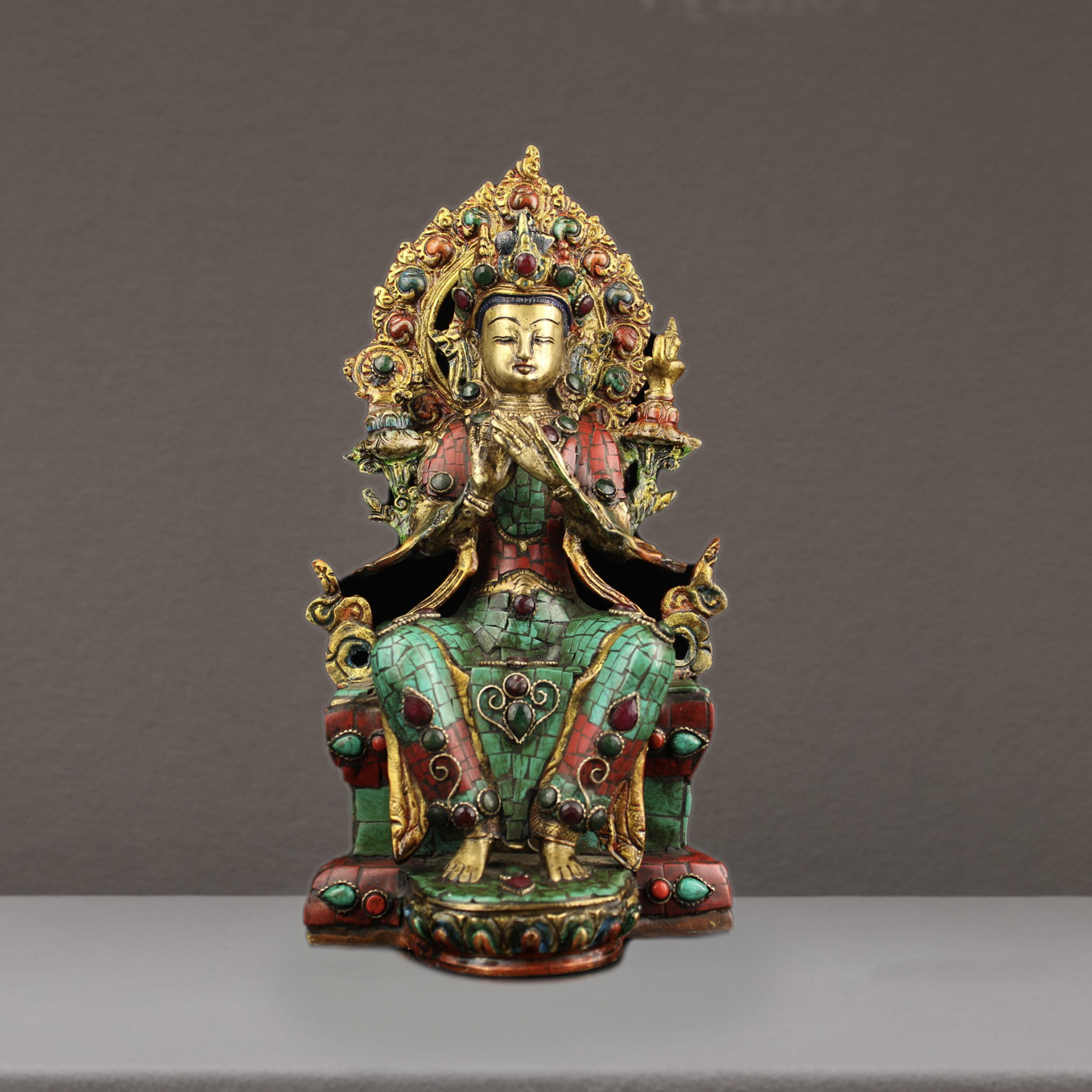 A pure hand-made bronze Buddha inlaid with precious stones, painted and painted with gold