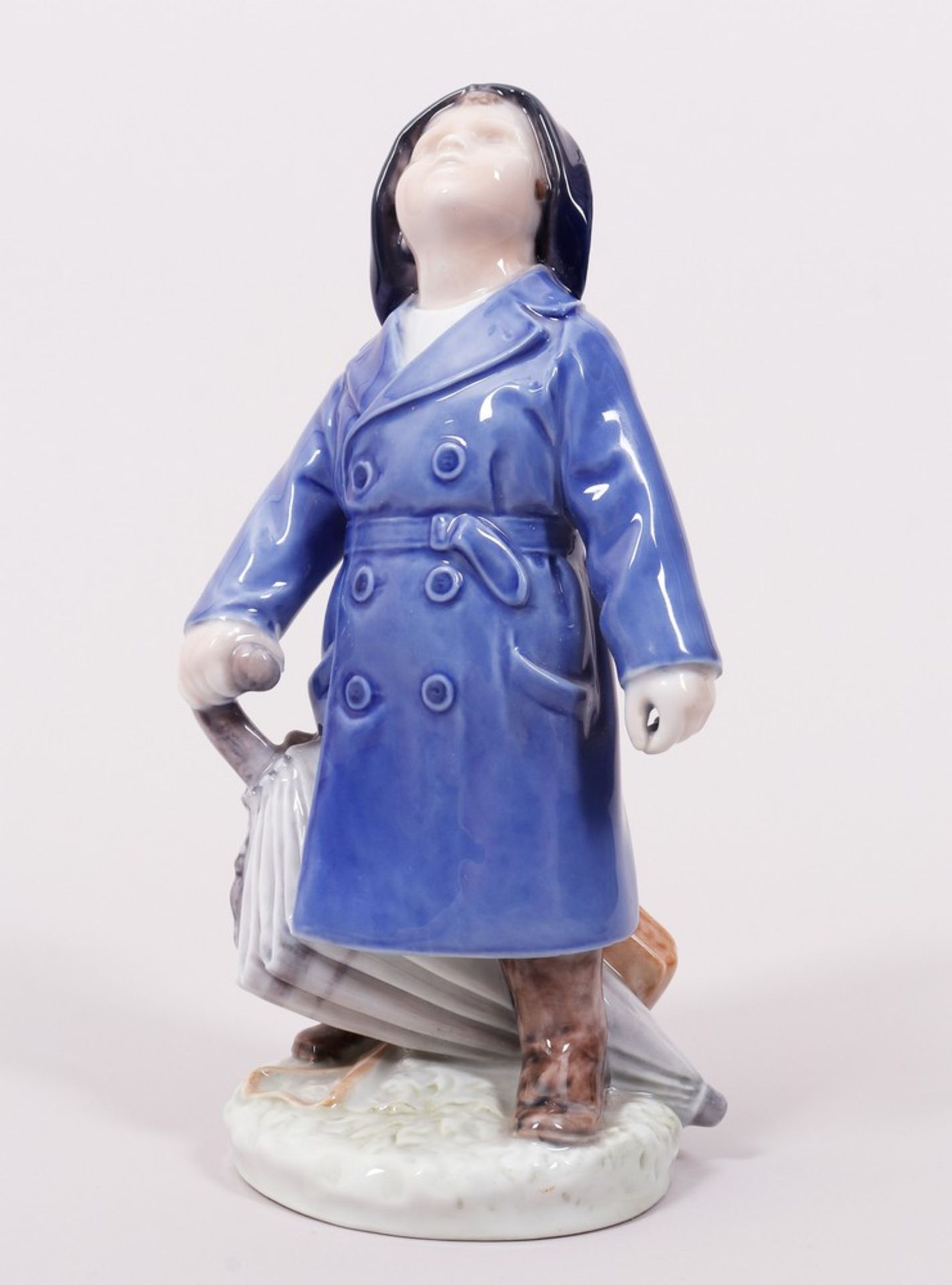 Boy with raincoat and umbrella, design Ada Bonfils for Royal Copenhagen, Denmark, 20th C.