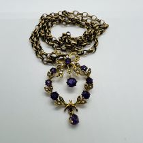 An Edwardian amethyst and seed pearl wreath pendant, with a 9ct gold belcher chain. The pendant is