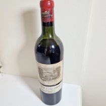 A single bottle of 1953 Chateau Lafite Rothschild Appellation Pauillac red wine.  Level below base