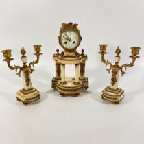 An early 20th Century onyx and gilt metal three piece mantle clock. As found. Loss to gilt chips