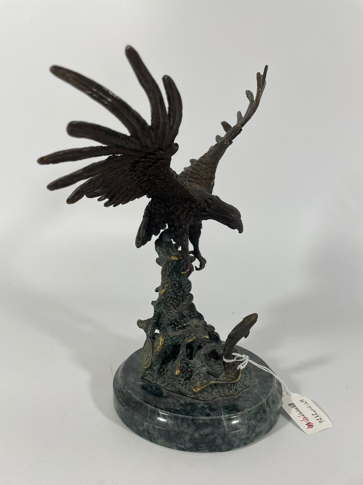 A bronze group of an eagle about to catch a leaping salmon. Approximately 25cm tall with good
