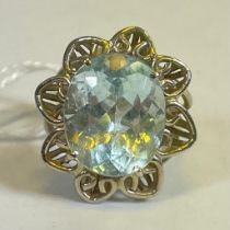 A handmade flower motif aquamarine cocktail ring. In white metal which tests as 9ct white gold. Size