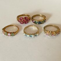 A collection of five 9ct yellow gold gem set rings. To include an opal and apatite set dress ring,