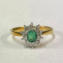 An 18ct yellow gold emerald and diamond cluster ring, featuring an estimated 0.25 carats of diamond.