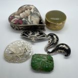 A carved jadeite panel, in an as found brooch setting, along with other collectible items. The
