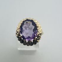 A 9ct gold Amethyst set cocktail ring.  Stone measures approximately 12mm x 10mm, size T.  Gross