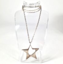 A Georg Jensen sterling silver star pendant.  Style number 147.  Designed by Henning Koppel in 1972.