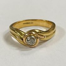 An 18ct yellow gold diamond solitaire ring. Featuring an estimated 0.20 carat diamond in a raised