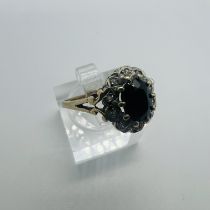 A 9ct sapphire and diamond cluster ring. Size M. Approximate weight 3 grams.