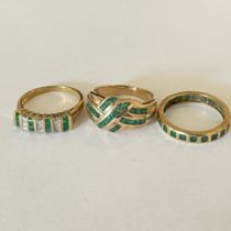 Collection Of three emerald set dress rings. Featuring a "9K" stamped emerald set eternity ring,