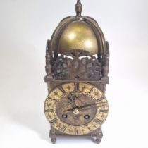 A brass lantern clock with a French 8 day striking movement.  In running order with key.  26cm tall