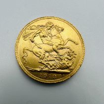 A George V gold Sovereign coin, dated 1913.