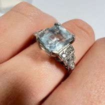 A diamond and aquamarine Art Deco style dress ring. Set in white metal marked "Plat" to the shank.