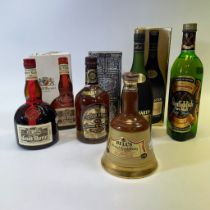 A bottle of Glenfiddich pure malt Scotch Whisky, a bottle of Bells Whisky, a bottle of Grand Marnier