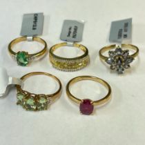 A yellow and white diamond set ring along with four other 9ct gold gem set dress rings. All size