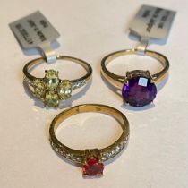 A group of three 9ct yellow gold gem set rings Featuring an Amethyst solitaire ring, and two further