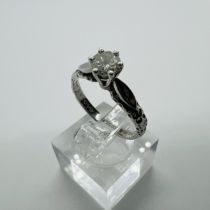 An 18ct white gold raised setting diamond solitaire ring. Set with an estimated 0.40 carat round